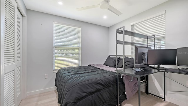 bedroom with a closet, wood finished floors, a ceiling fan, and recessed lighting