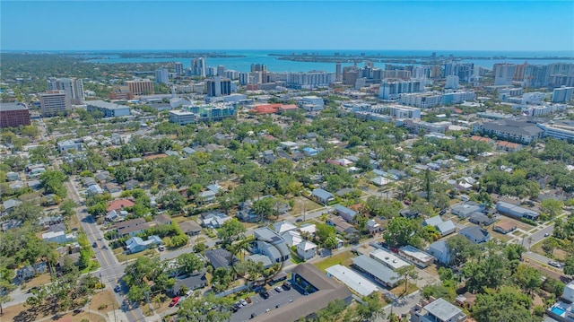 birds eye view of property featuring a city view and a water view