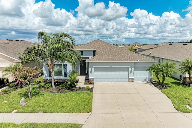 15612 Trinity Fall Way, Bradenton, FL 34212 - ranch-style home featuring a garage, stucco siding, concrete driveway, and a front yard