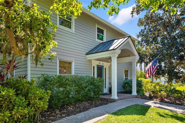1434 Ladue Ln, Sarasota, FL 34231 - view of front of home featuring a standing seam roof, metal roof, and a porch