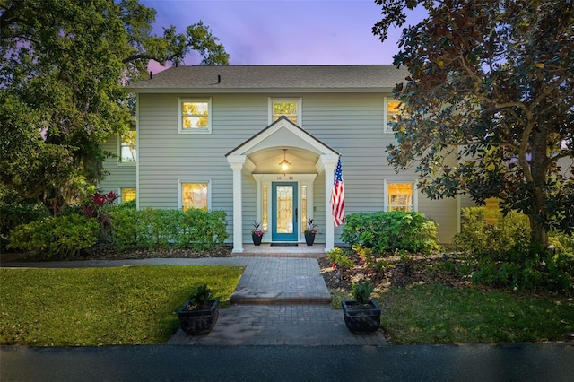 1434 Ladue Ln, Sarasota, FL 34231 - view of front facade with a yard and a shingled roof
