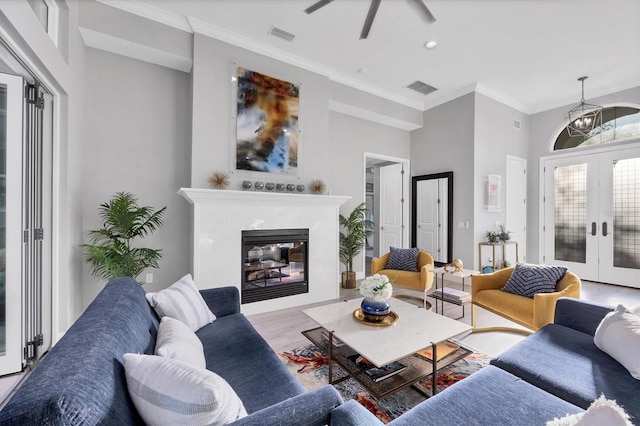 7257 Greystone St, Lakewood Ranch, FL 34202 - living room featuring visible vents, wood finished floors, a ceiling fan, a glass covered fireplace, and french doors