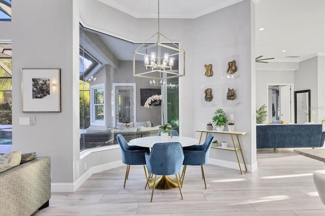 7257 Greystone St, Lakewood Ranch, FL 34202 - dining room with a healthy amount of sunlight, a chandelier, crown molding, and light wood finished floors