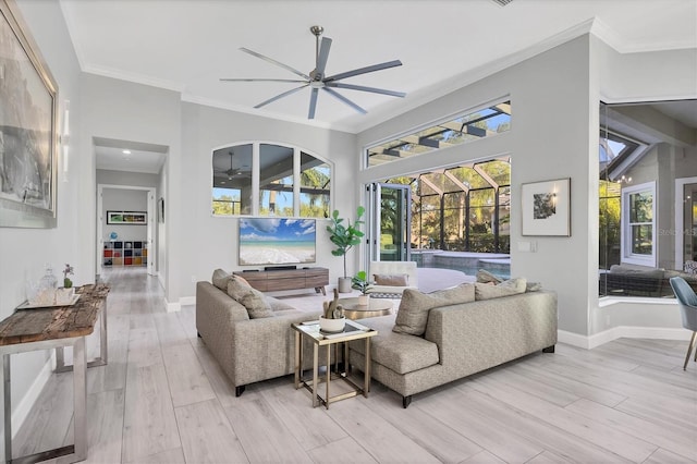 7257 Greystone St, Lakewood Ranch, FL 34202 - living area with a sunroom, light wood-style flooring, baseboards, ceiling fan, and ornamental molding