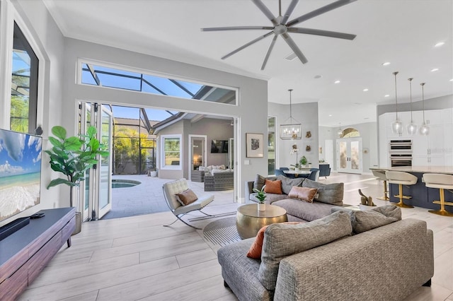 7257 Greystone St, Lakewood Ranch, FL 34202 - living area with a sunroom, light wood-style flooring, crown molding, recessed lighting, and a ceiling fan