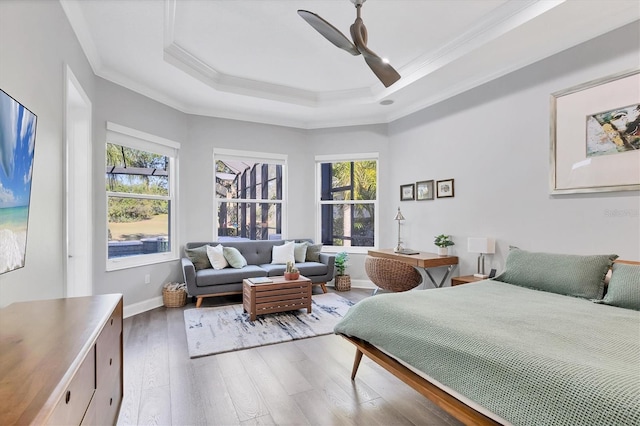 7257 Greystone St, Lakewood Ranch, FL 34202 - bedroom featuring a tray ceiling, multiple windows, crown molding, and hardwood / wood-style flooring
