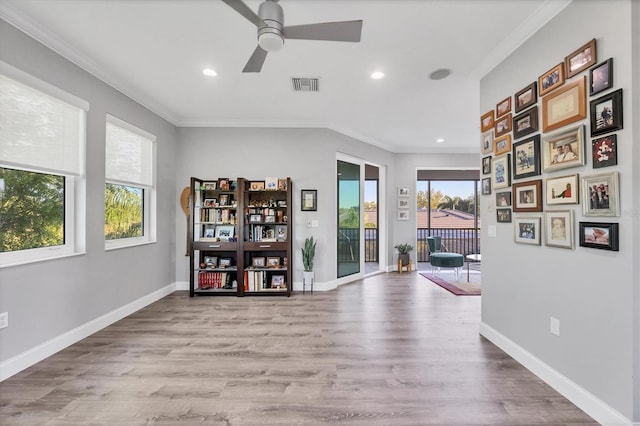 7257 Greystone St, Lakewood Ranch, FL 34202 - interior space with visible vents, crown molding, wood finished floors, and a ceiling fan