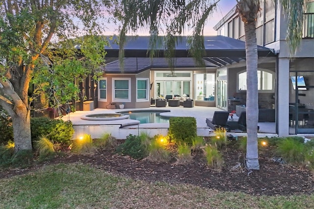 7257 Greystone St, Lakewood Ranch, FL 34202 - back of property at dusk with a patio area, stucco siding, an outdoor hangout area, an outdoor pool, and ceiling fan