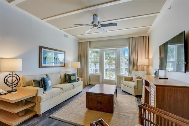living room featuring wood finished floors, beam ceiling, ceiling fan, and visible vents