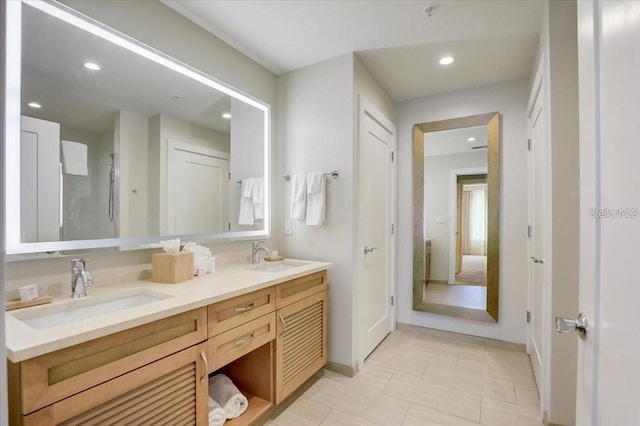 bathroom with double vanity, recessed lighting, tile patterned flooring, and a sink