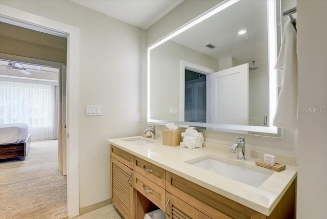 full bathroom with ensuite bathroom, double vanity, visible vents, and a sink