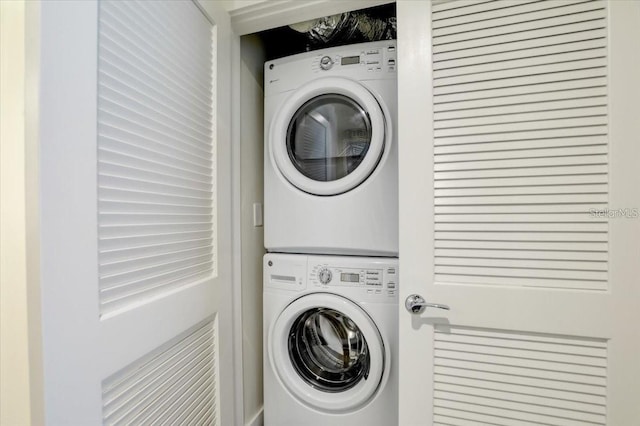 laundry area featuring stacked washer and dryer and laundry area