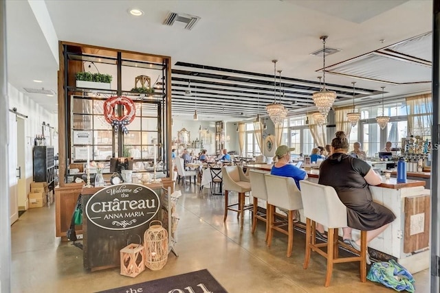 dining area featuring concrete flooring and visible vents