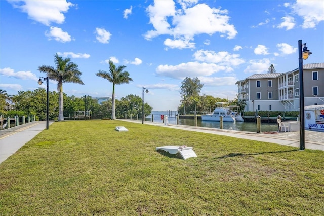 view of community featuring a water view and a yard