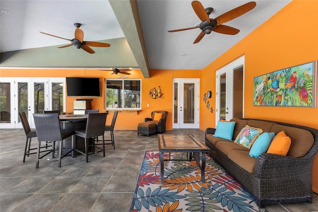 exterior space with lofted ceiling, french doors, a textured ceiling, and a ceiling fan