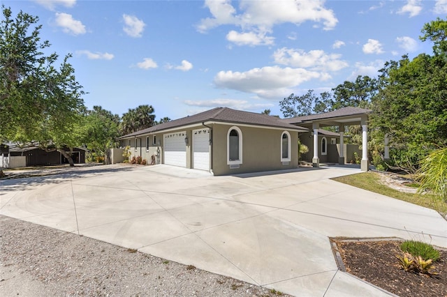 view of front of home featuring stucco siding, an attached garage, concrete driveway, and roof with shingles