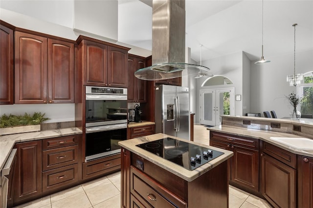 kitchen with high vaulted ceiling, a sink, island range hood, light tile patterned floors, and appliances with stainless steel finishes