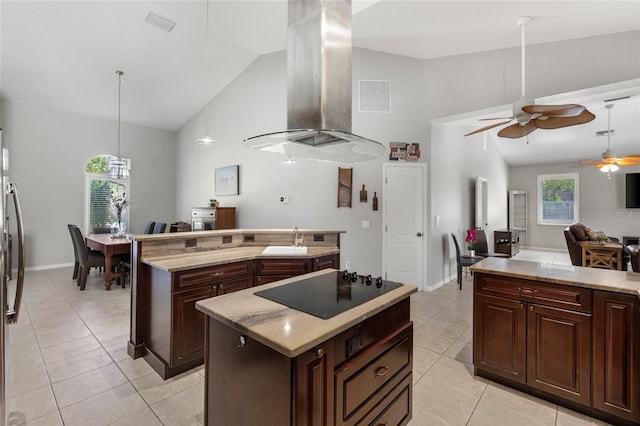 kitchen featuring black electric cooktop, a center island, island exhaust hood, a ceiling fan, and light tile patterned floors