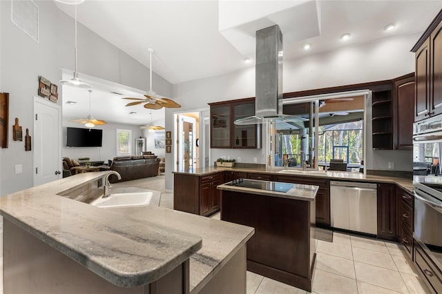 kitchen with island exhaust hood, visible vents, a sink, a kitchen island with sink, and appliances with stainless steel finishes