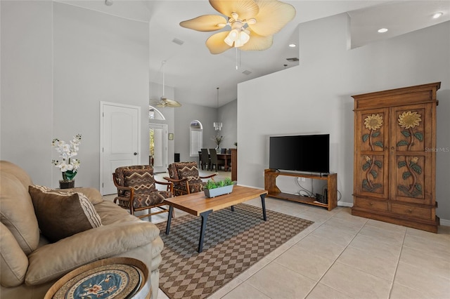 living room featuring baseboards, high vaulted ceiling, ceiling fan, and light tile patterned floors