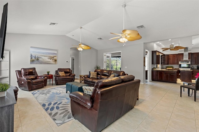 living room with a ceiling fan, visible vents, and light tile patterned floors