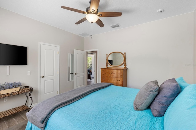 bedroom with visible vents, baseboards, and ceiling fan