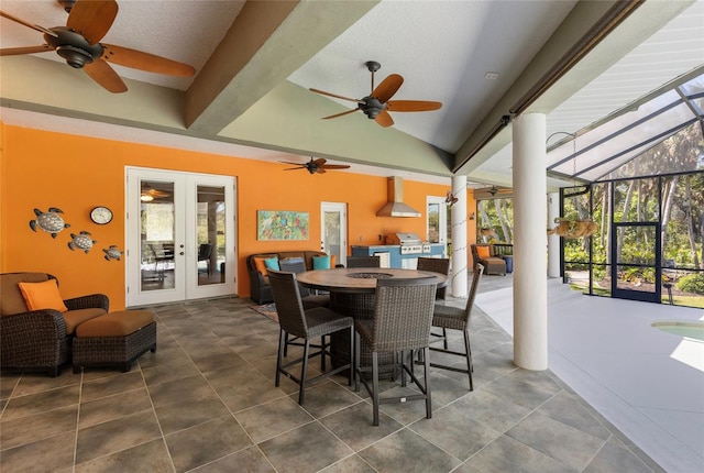 view of patio / terrace featuring an outdoor kitchen, a ceiling fan, and french doors