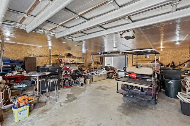 garage with a garage door opener and a workshop area