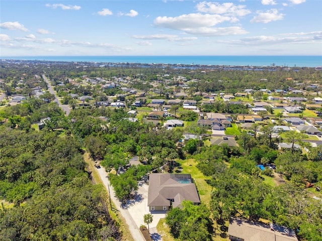 drone / aerial view with a water view and a residential view