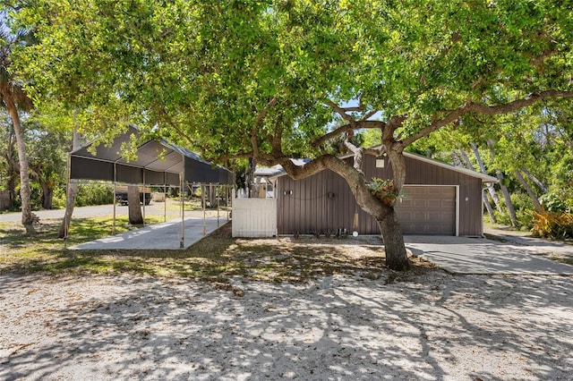 view of side of home with driveway and fence