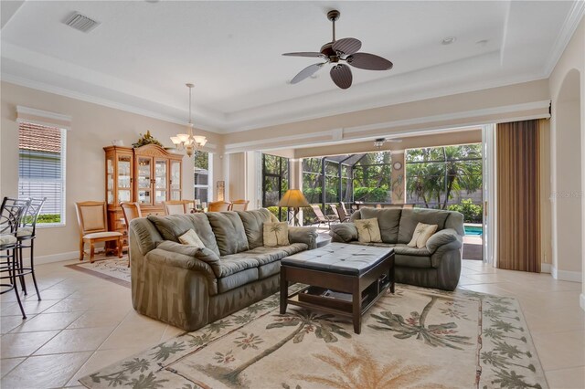 9818 Portside Ter, Bradenton, FL 34212 - living room with light tile patterned flooring, a raised ceiling, baseboards, ceiling fan with notable chandelier, and visible vents