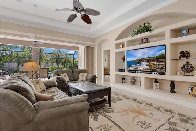 9818 Portside Ter, Bradenton, FL 34212 - living area with crown molding, tile patterned floors, arched walkways, ceiling fan, and built in features