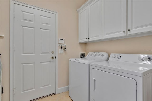 9818 Portside Ter, Bradenton, FL 34212 - clothes washing area featuring washing machine and clothes dryer, cabinet space, baseboards, and light tile patterned floors