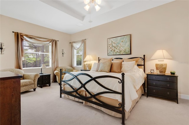 9818 Portside Ter, Bradenton, FL 34212 - bedroom featuring baseboards, a raised ceiling, a ceiling fan, and light carpet
