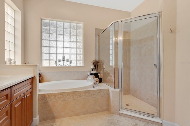9818 Portside Ter, Bradenton, FL 34212 - full bath featuring a bath, a stall shower, tile patterned flooring, and vanity