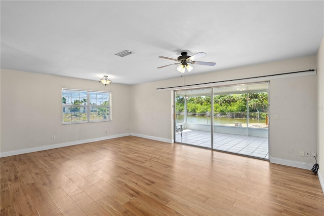 1665 Harmony Dr, Port Charlotte, FL 33952 - spare room with a wealth of natural light, visible vents, a ceiling fan, and wood finished floors
