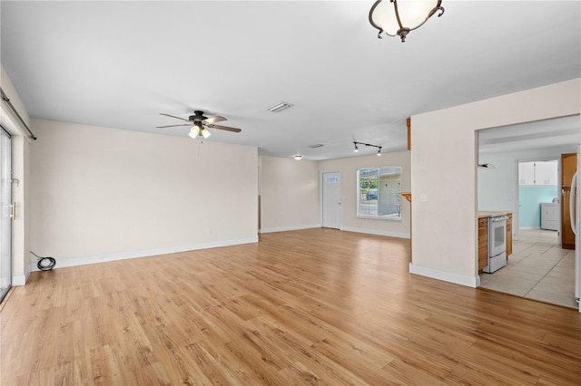 1665 Harmony Dr, Port Charlotte, FL 33952 - unfurnished living room with light wood-style flooring, baseboards, ceiling fan, and visible vents