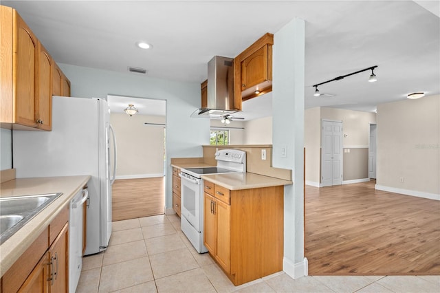 1665 Harmony Dr, Port Charlotte, FL 33952 - kitchen with light countertops, white appliances, exhaust hood, light tile patterned flooring, and a ceiling fan