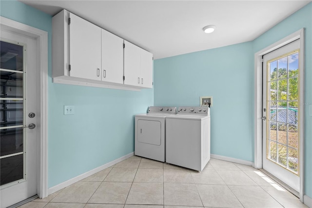 1665 Harmony Dr, Port Charlotte, FL 33952 - laundry area featuring washing machine and clothes dryer, cabinet space, baseboards, and light tile patterned floors