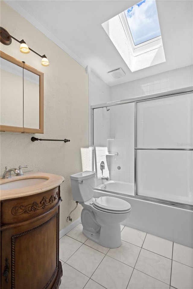 1665 Harmony Dr, Port Charlotte, FL 33952 - full bathroom with vanity, toilet, bath / shower combo with glass door, tile patterned floors, and a skylight