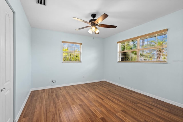 1665 Harmony Dr, Port Charlotte, FL 33952 - empty room featuring baseboards, visible vents, wood finished floors, and a ceiling fan