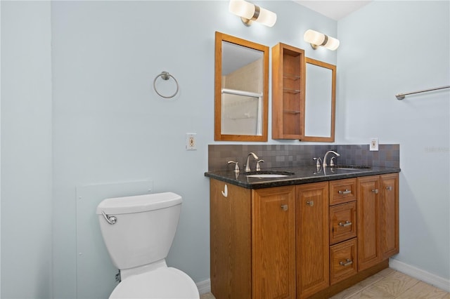 1665 Harmony Dr, Port Charlotte, FL 33952 - full bathroom featuring a sink, toilet, and tasteful backsplash