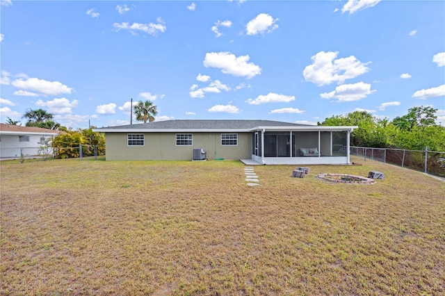 1665 Harmony Dr, Port Charlotte, FL 33952 - rear view of house with a lawn, a sunroom, a fenced backyard, and cooling unit