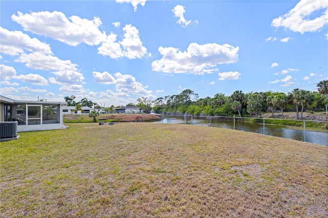 1665 Harmony Dr, Port Charlotte, FL 33952 - view of yard with central AC unit, a water view, and a sunroom