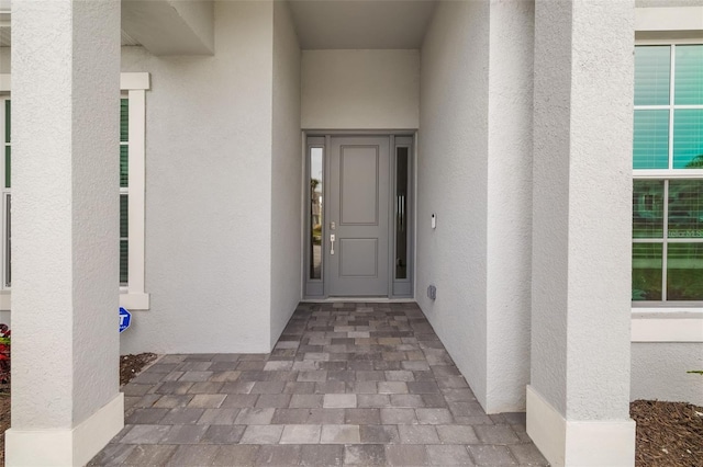 12557 Galapagos Ct, Venice, FL 34293 - doorway to property featuring stucco siding