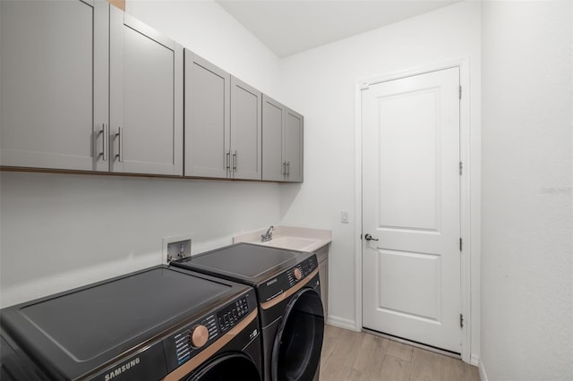 12557 Galapagos Ct, Venice, FL 34293 - washroom featuring cabinet space, independent washer and dryer, baseboards, and light wood-style floors