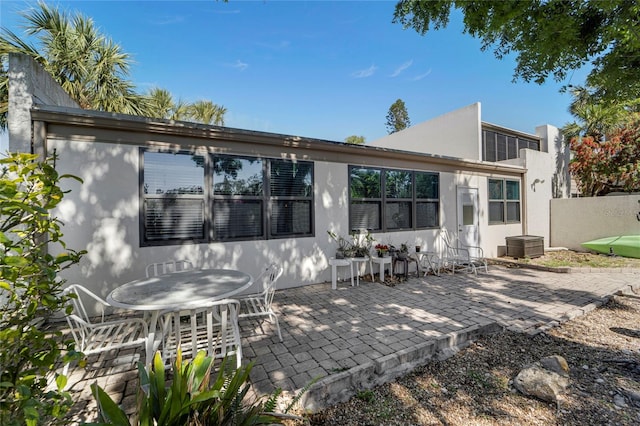 501 Lakeside Dr Unit 501, Bradenton, FL 34210 - rear view of house featuring fence, outdoor dining space, stucco siding, and a patio