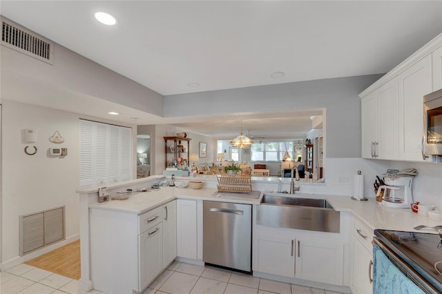 501 Lakeside Dr Unit 501, Bradenton, FL 34210 - kitchen featuring a sink, light countertops, visible vents, and appliances with stainless steel finishes