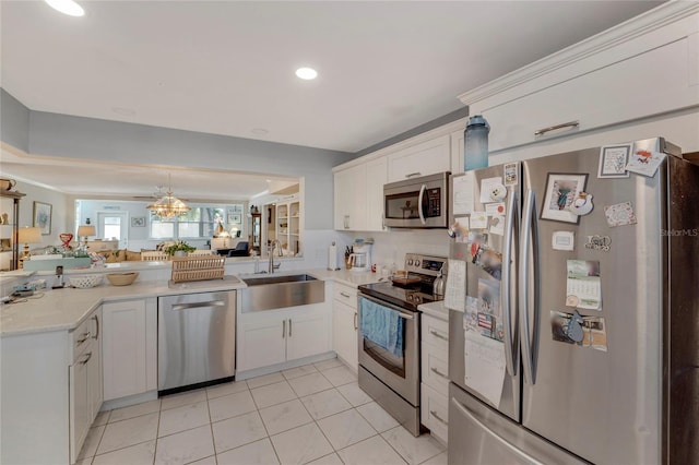 501 Lakeside Dr Unit 501, Bradenton, FL 34210 - kitchen featuring a peninsula, stainless steel appliances, white cabinetry, a sink, and open floor plan