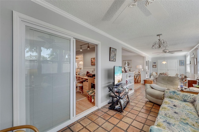 501 Lakeside Dr Unit 501, Bradenton, FL 34210 - living room featuring ceiling fan with notable chandelier, a textured ceiling, and crown molding